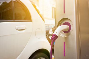 Electric car being charged at a charging station