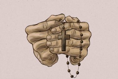 Hands holding a rosary