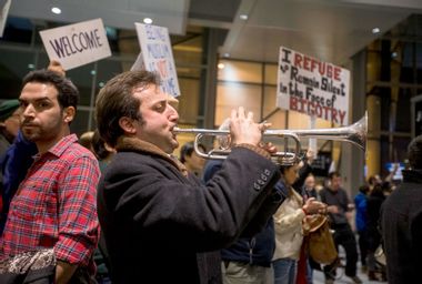 Trumpeter at an anti-immigration ban rally