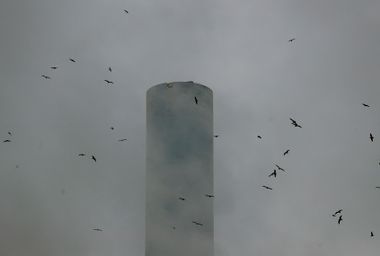 Smoke billows from the chimney of the Figino municipal waste incinerator