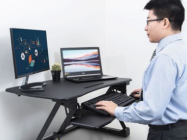 Image for Bring your work to eye level with a standing desk converter