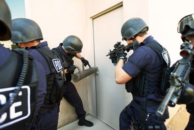 Police officers breaking down doors