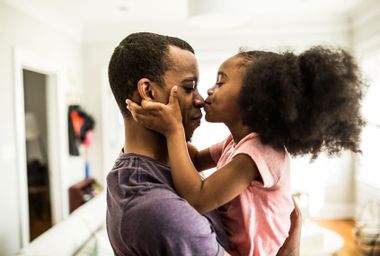 Daughter kissing father on the nose