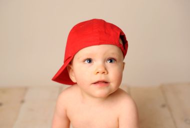 Baby wearing a red hat