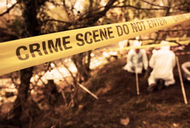 Police crime scene investigators look for evidence