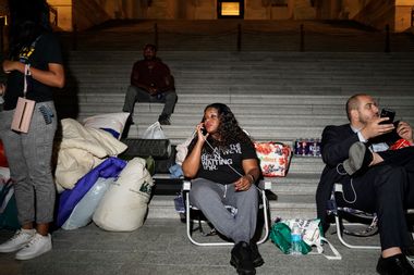 Rep. Cori Bush speaks with supporters as she spends the night outside the U.S. Capitol to call for for an extension of the federal eviction moratorium on July 31, 2021.