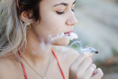 Close-Up Of Woman Smoking Marijuana Joint