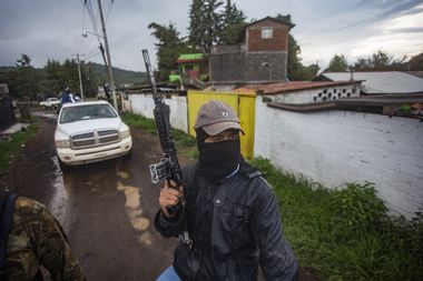 Members of the self-defense group Pueblos Unidos carry out guard duties in protection of avocado plantations in Ario de Rosales, Mexico.