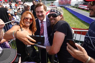 Supporters of former President Donald Trump take a selfie with My Pillow founder Mike Lindell