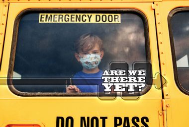 Little Sad Boy Kid Student In Protective Face Mask Looking Out Of School Yellow Bus Window