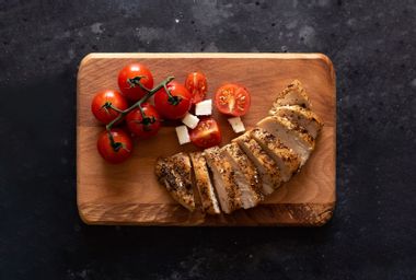 Chicken and tomatoes on a board