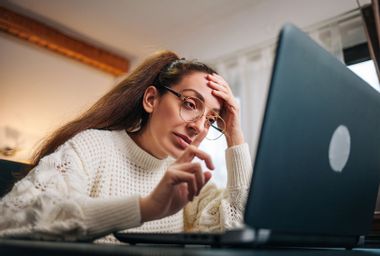 Stressed business woman working from home on laptop