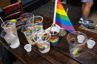 Empty drinks cover a bar table during Gay Pride celebrations