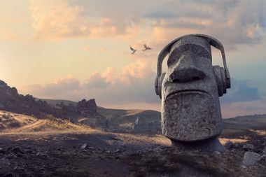 Stone Statue Head Wearing Headphones In Remote Rocky Dawn Landscape