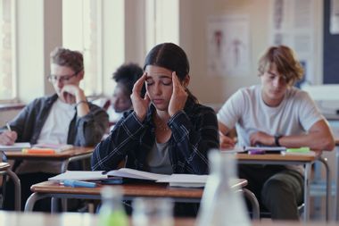 Shot of a student struggling in a classroom