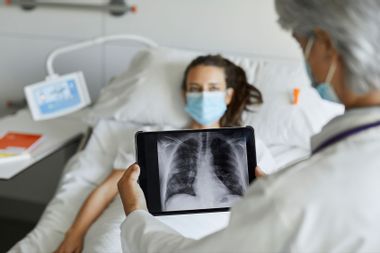 Healthcare professional is discussing an x-ray with a woman in the hospital