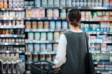 WOman standing in front of products at the grocery store