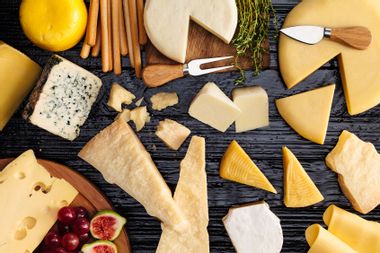 A table filled with a wide variety of cheeses