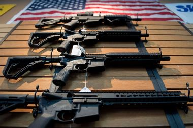 Assault rifles hang on the wall for sale