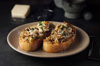 Toasted sourdough bread with sauteed mushroom and hard goat cheese