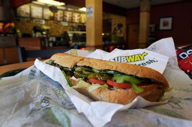 A Subway sandwich is seen in a restaurant