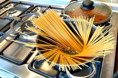 Spaghetti in a pot on a stove