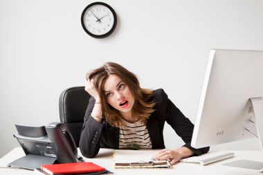 Stressed woman working in office.