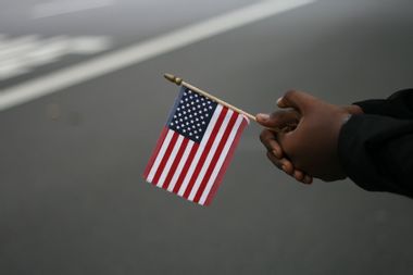 Hands holding a small American flag