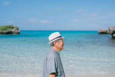 Senior Japanese man on tropical beach, Ikema Island of Miyako Islands, Okinawa, Japan