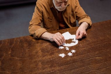 Senior man doing a jigsaw puzzle