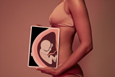 Woman holding tablet showing pregnancy illustration