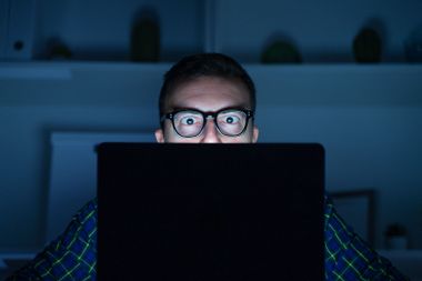 Man using laptop at night