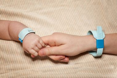 Newborn and mom with hospital bracelets