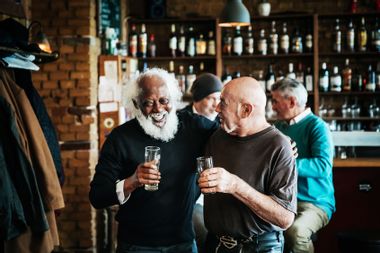 A couple of old friends catching up over a drink at a craft beer bar together