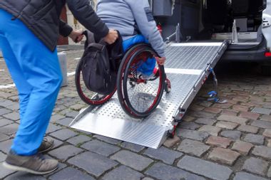 Disabled person on wheelchair using car lift