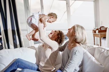 Happy mother with baby girl and grandmother at home