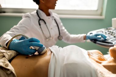 Doctor performs ultrasound woman
