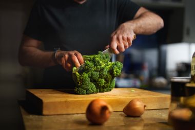 Man cutting broccoli