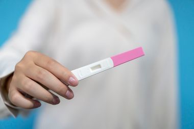 A woman holds a pregnancy test