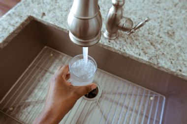 filling glass tap water from faucet 1278680706