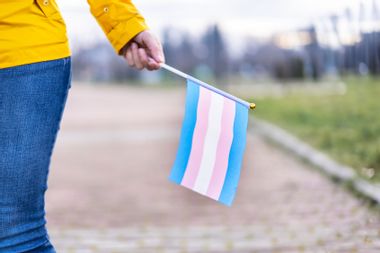 Holding a transgender flag