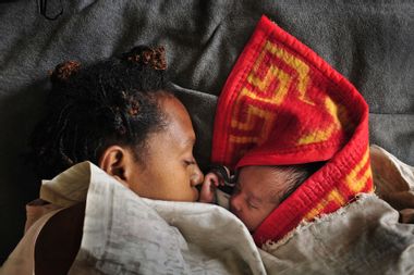 woman sleeps with her baby Papua New Guinea