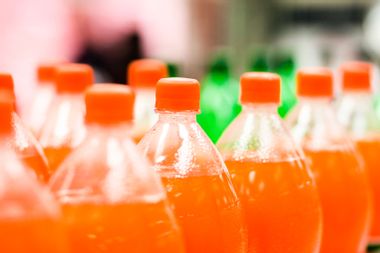 Bottles of orange soda in a supermarket