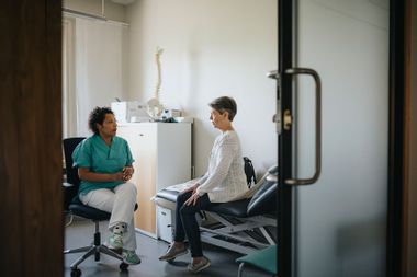 Elderly patient talking to doctor