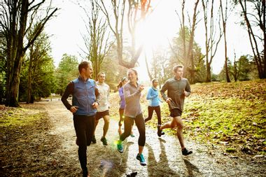 Friends running together in a park