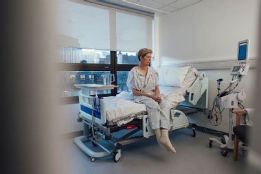 Woman sitting in hospital bed