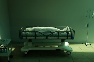 Dead body covered in sheet in hospital