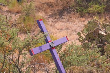 purple cross planted in desert