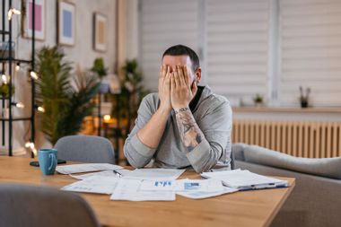 Man Going Through Bills Feeling Stressed