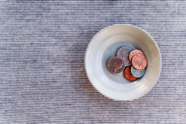 Bowl with small pile of coins